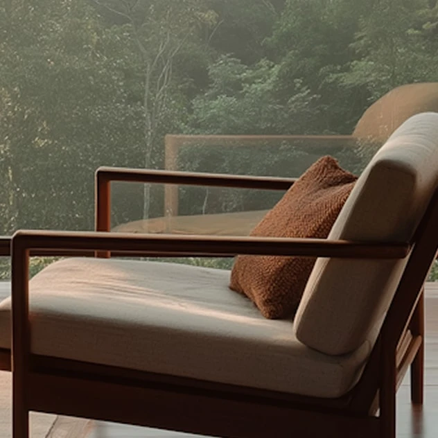 Lounge armchair with a rust bouclé cushion looking out at a misty forest